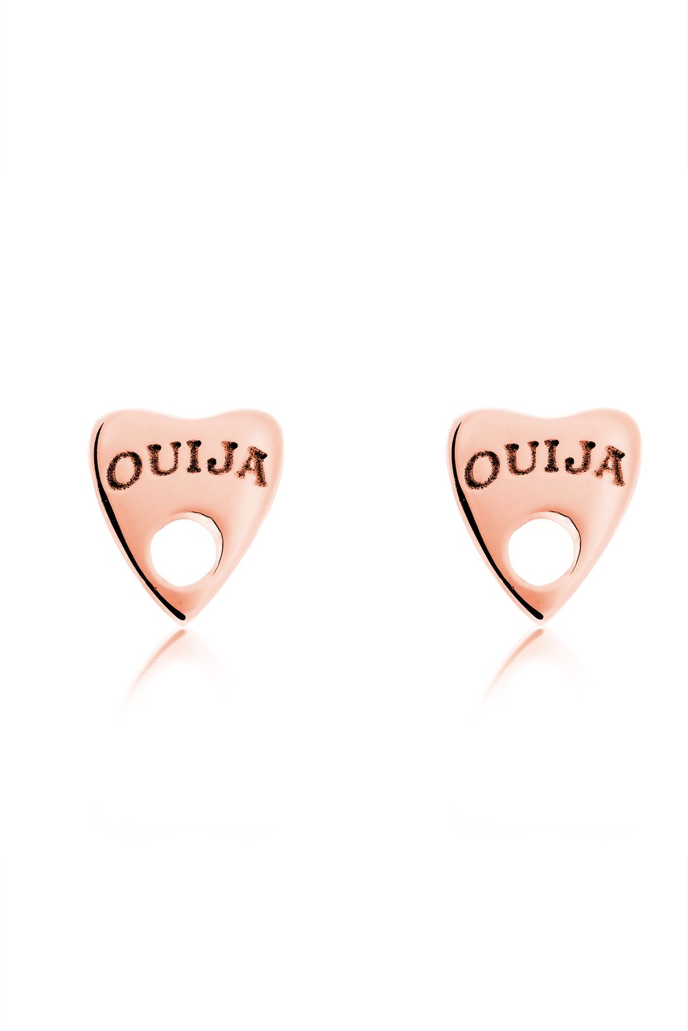 A pair of rose gold, heart-shaped Ouija 9ct Gold Earrings by Cosmic Boulevard resembling planchettes, each engraved with the word "OUIJA" at the top, against a white background. These handmade jewelry pieces have a small hole at the bottom point of the hearts, adding a touch of mysticism and spirituality.