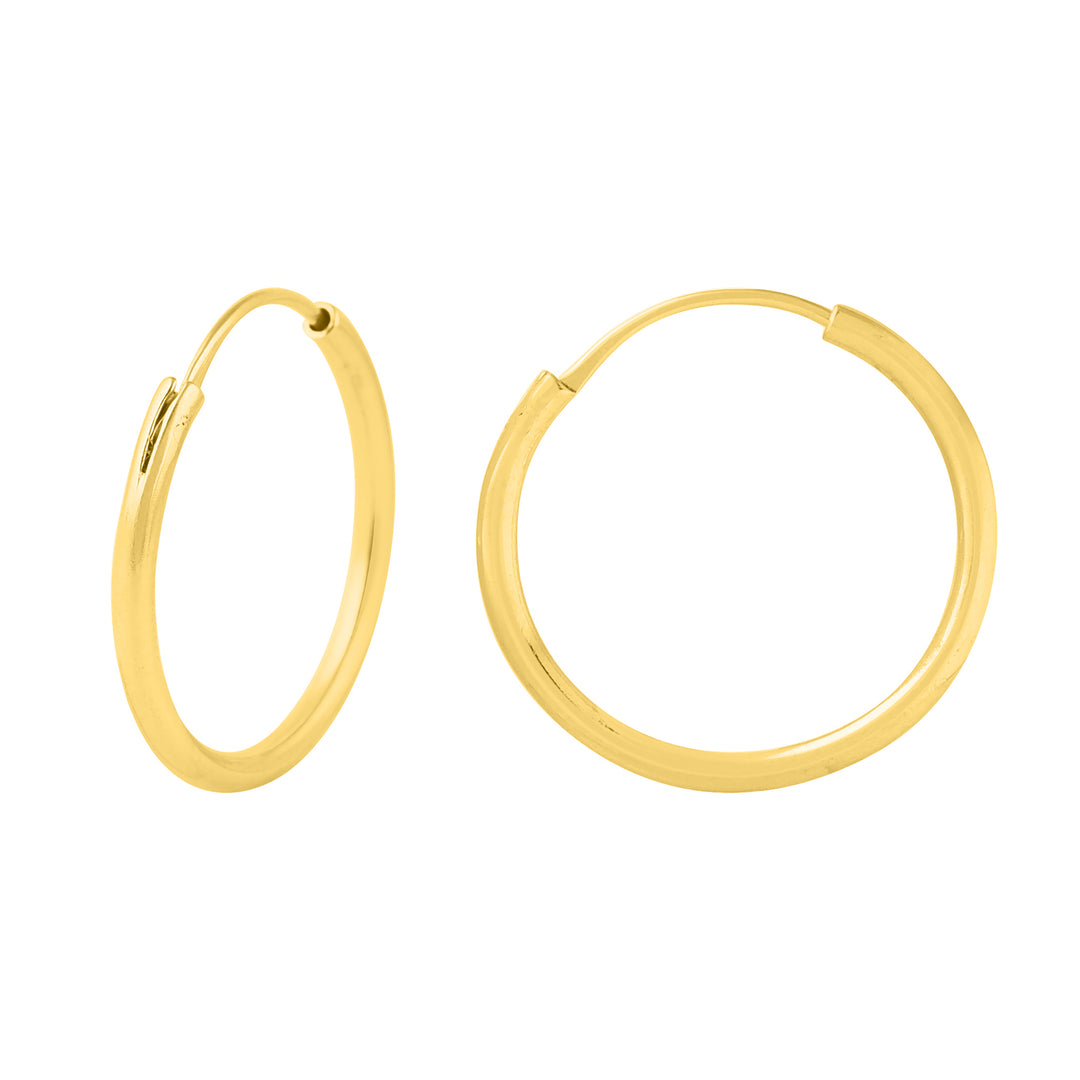Two simple, golden hoop earrings are shown against a white background. One earring is closed, displaying its complete circular shape, while the other is open, revealing its fastening mechanism. The Sally Gold Hoops by Watermelon tropical have a sleek and polished finish with a 24mm diameter.