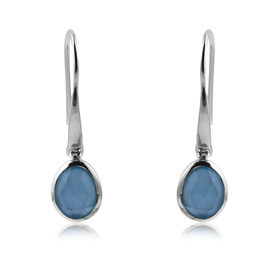 A pair of elegant Aqua Chalcedony Earrings by Watermelon Tropical, featuring oval-shaped gemstones set in a simple, sleek sterling silver bezel. The smooth, faceted surface of the gemstones adds a touch of sparkle to these hook-style drop earrings.