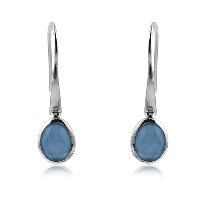 A pair of elegant Aqua Chalcedony Earrings by Watermelon Tropical, featuring oval-shaped gemstones set in a simple, sleek sterling silver bezel. The smooth, faceted surface of the gemstones adds a touch of sparkle to these hook-style drop earrings.