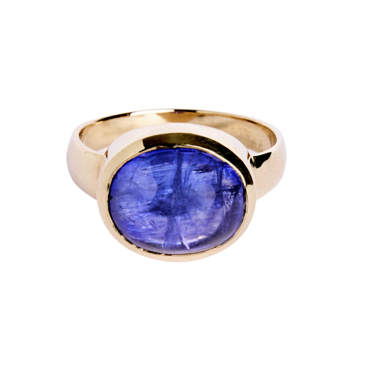 9ct Yellow gold ring with a large oval cabochon Tanzanite, which is a dark blue purple colour. The 9ct yellow gold band is D shaped with the widest at the back at 3mm.