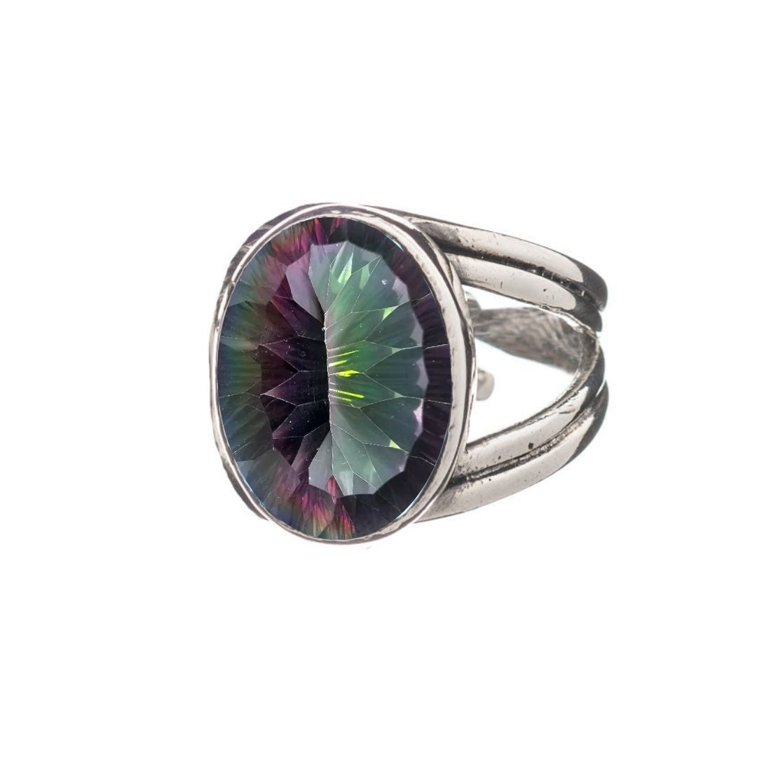The Gallardo & Blaine Designs Dewberry Ring showcases a bold sterling silver band set with a large oval, faceted green-purple iridescent gemstone, photographed on a white background.