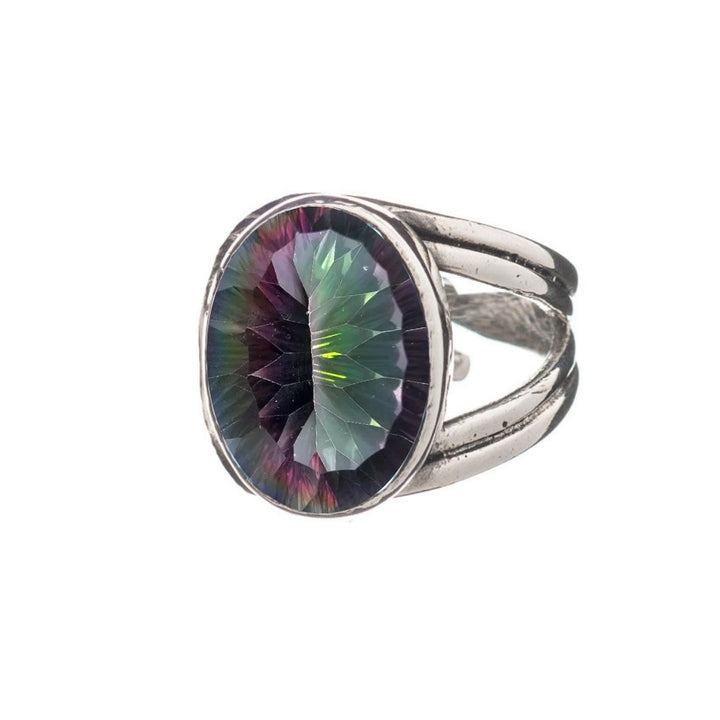 The Gallardo & Blaine Designs Dewberry Ring showcases a bold sterling silver band set with a large oval, faceted green-purple iridescent gemstone, photographed on a white background.