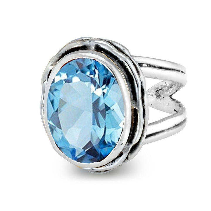 The Magnolia Ring by Gallardo & Blaine Designs features a large oval-cut gemstone set in decorative silver gold with a split shank band, shown on a white background.