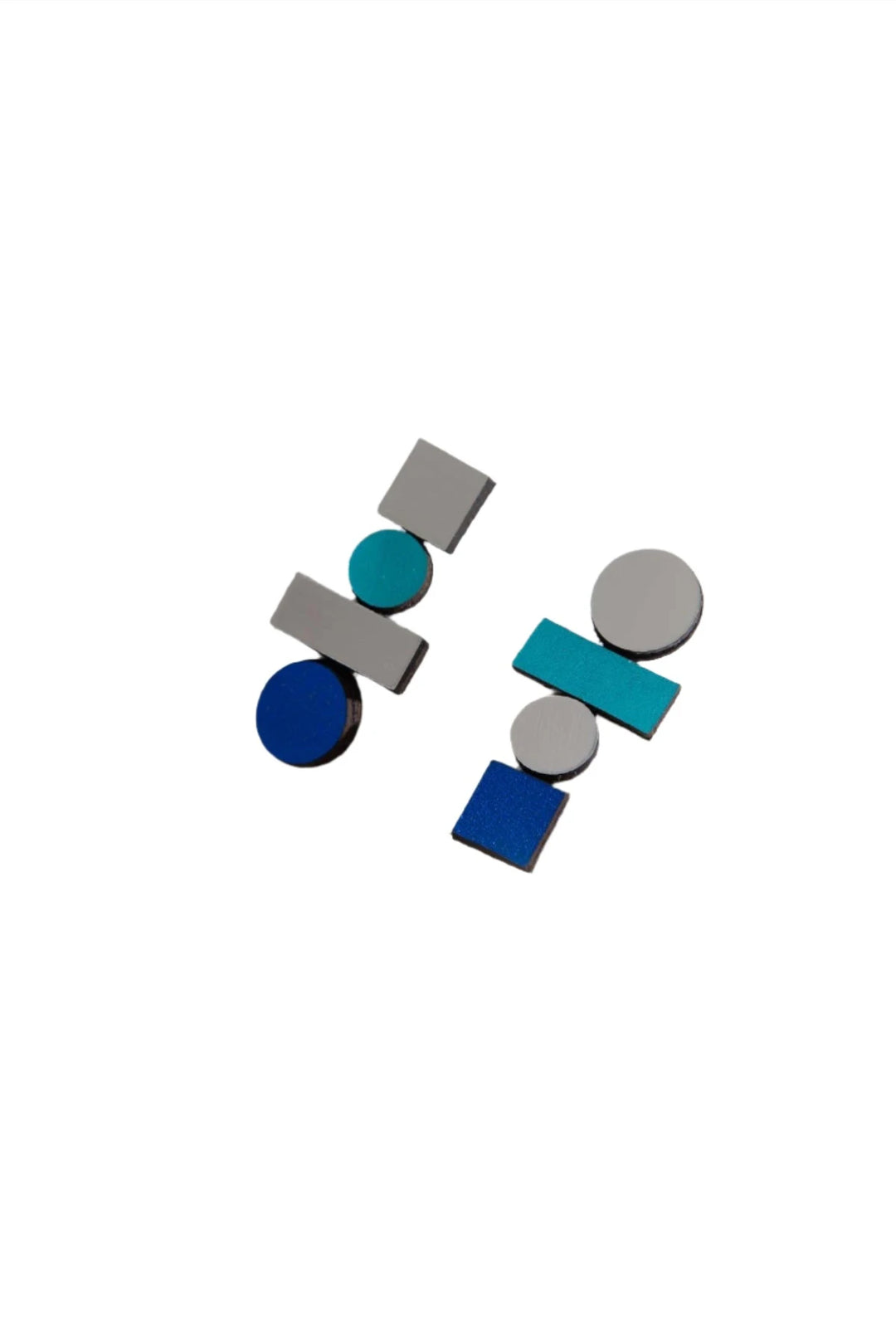 A striking pair from the Iskin Sisters' Bauhaus Earrings Large collection, boasting modern geometric designs that blend a variety of blue, teal, and silver shapes. These earrings uniquely combine circles, rectangles, and squares to create an abstract and contemporary aesthetic with exceptional craftsmanship.