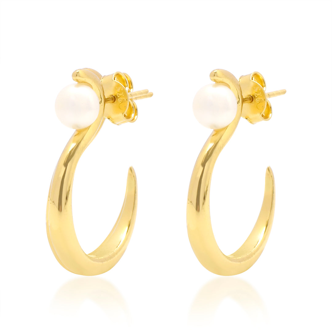 A pair of elegant Celia Pearl Earrings featuring a single white pearl on each. These hoops are crafted from 19 carat gold and are polished to a shiny, smooth, curved design. The hypoallergenic jewellery is displayed against a plain white background.
