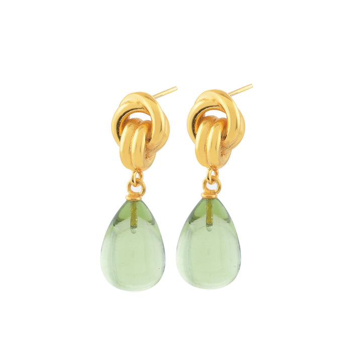 Introducing the Chunky Knot Earrings from Shyla, featuring a stylish pair of high-shine gold knotted drop earrings adorned with dangling teardrop-shaped green gemstones. The chunky knot forms the post, with the elegant green gemstones hanging directly below. These sophisticated earrings not only offer a chic and fashionable design but are also hypoallergenic, making them perfect for sensitive ears.