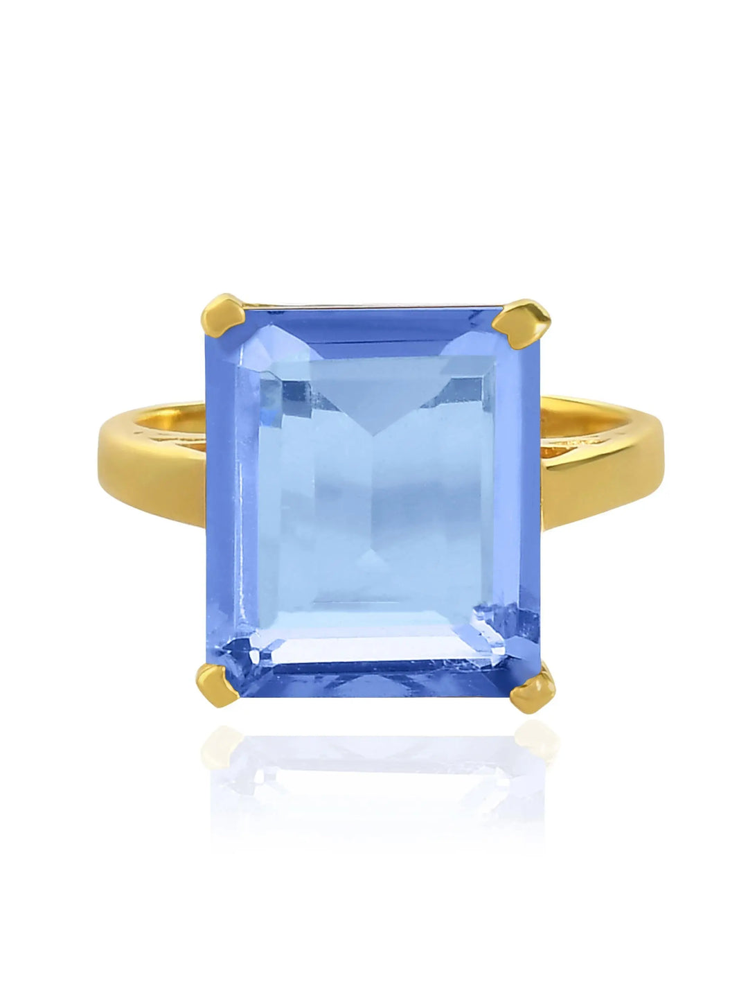 The Claudia Ring by Shyla is a vintage-inspired gold chunky ring with a large, emerald-cut light blue gemstone in a four-prong setting, shown on a white background.