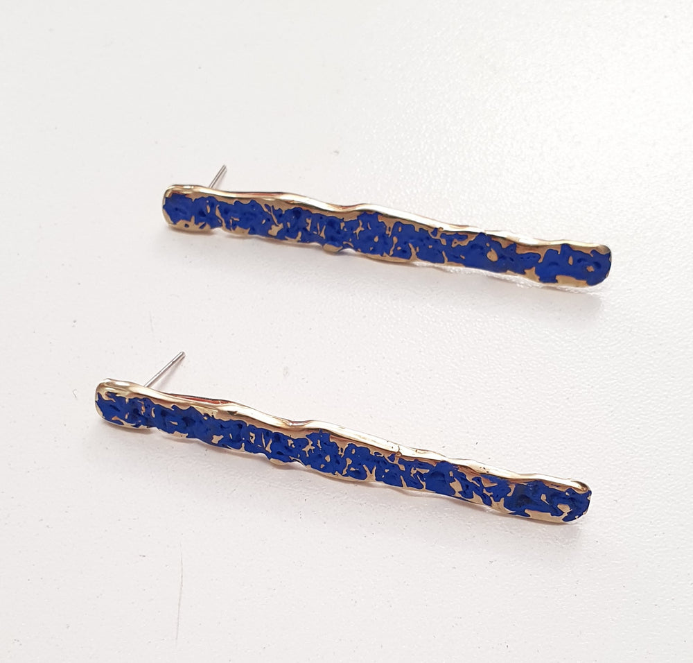These earrings are designed in gold plated silver with cobalt blue or forest green crackle texture finish and stud back .