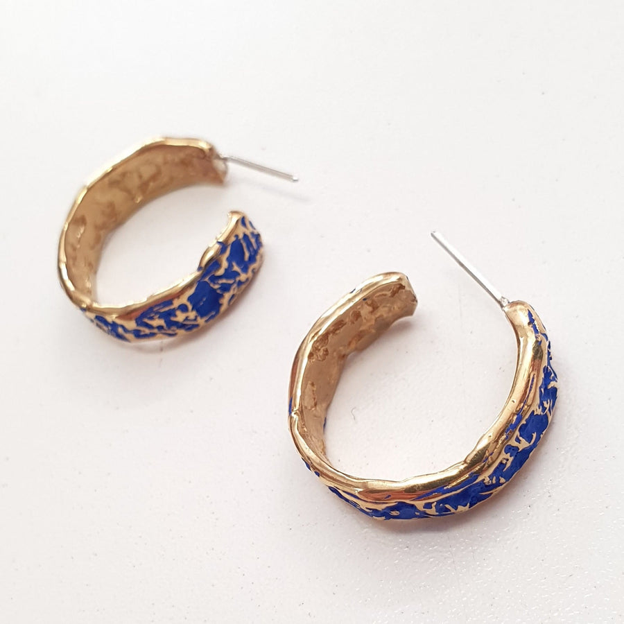 These hoop earrings are designed in gold plated silver with cobalt blue or forest green crackle texture finish and stud back .