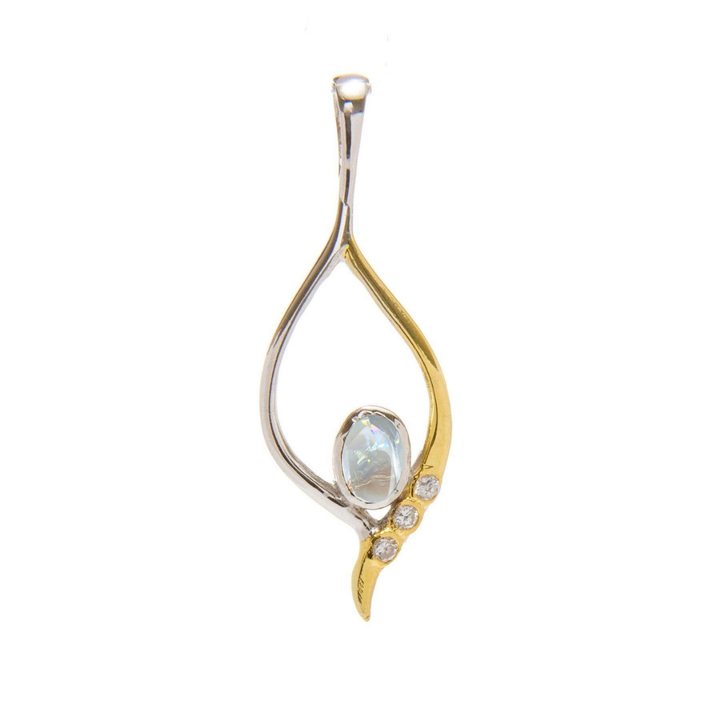 The Desert Star Pendant by Gallardo & Blaine Designs is a refined piece showcasing an oval moonstone in a fluid gold vermeil and sterling silver frame, highlighted by three diamonds on the gold curve.