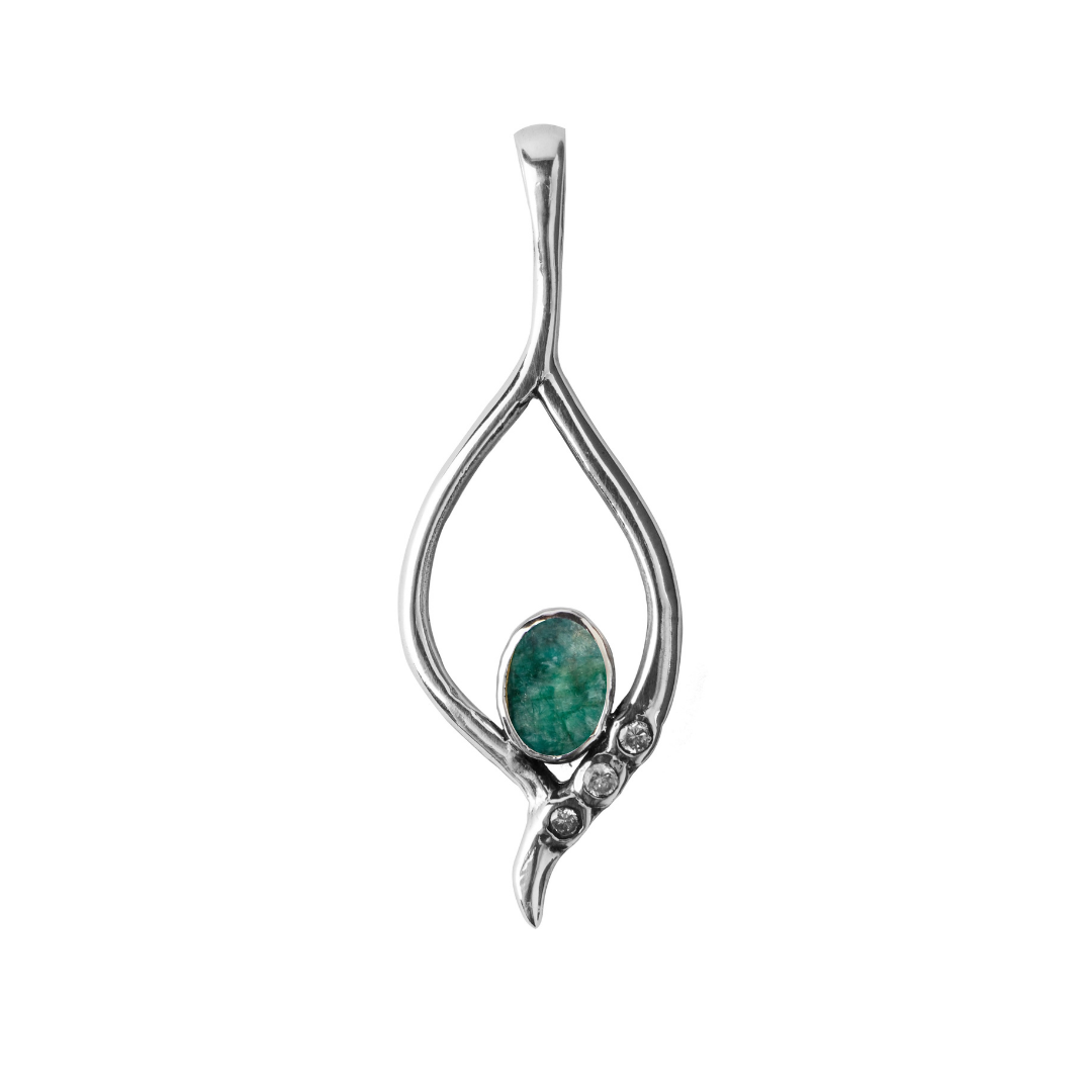 The Desert Star Pendant by Gallardo & Blaine Designs is a sterling silver piece featuring an open teardrop shape, a central green stone, and three small round stones, available in various gemstones. Its minimalist design embodies timeless sophistication.