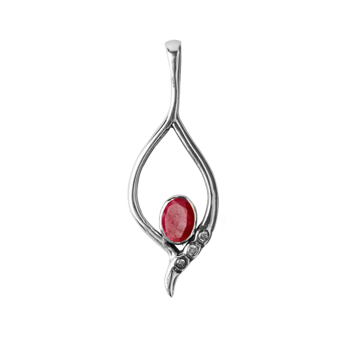 Introducing the Desert Star Pendant by Gallardo & Blaine Designs: a sterling silver piece with an abstract open teardrop design, featuring a central oval red gemstone and three smaller round clear stones on one side for added radiance.