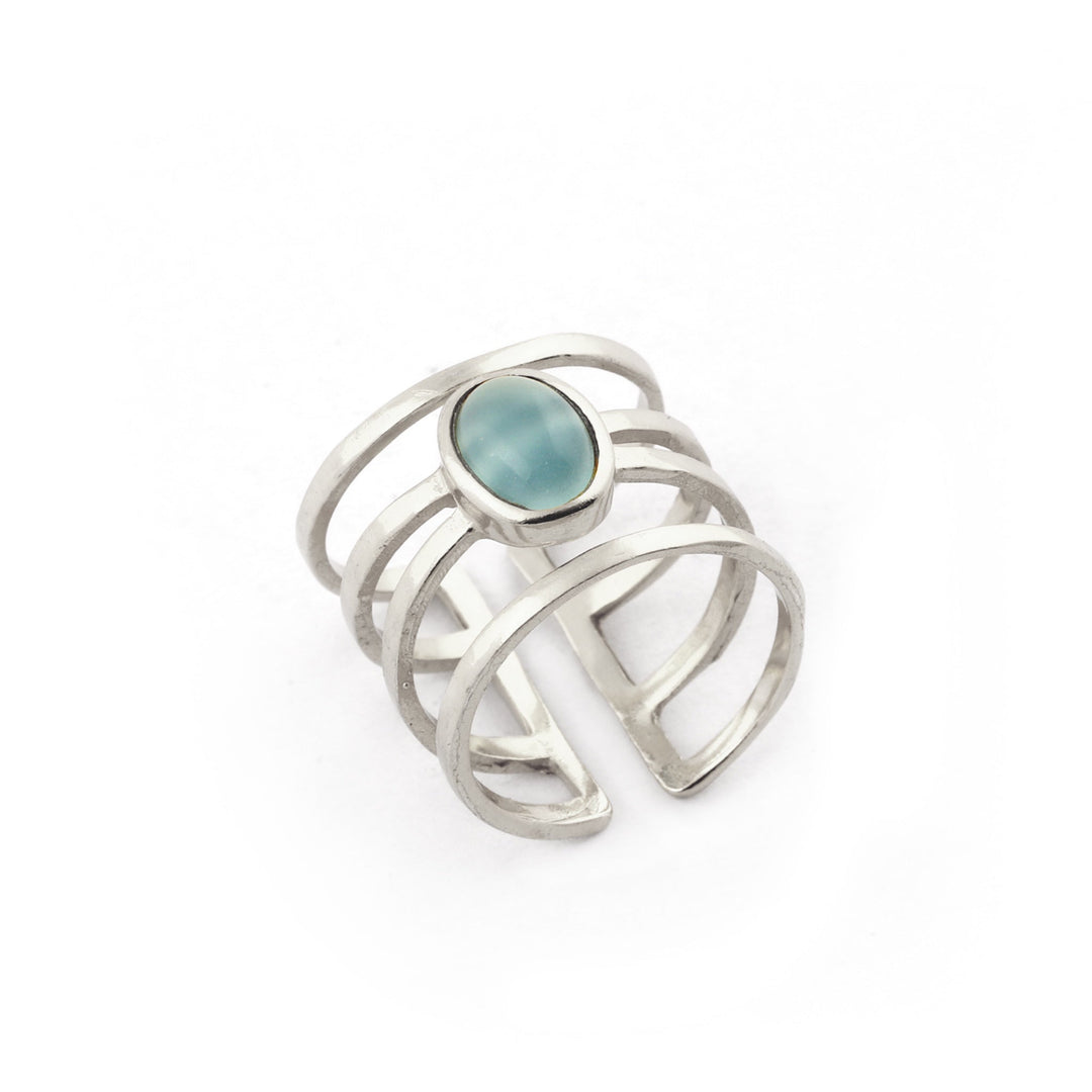 Discover the Andi Banded Ring in Amazonite by Watermelon Tropical, a minimalist yet elegant sterling silver ring. This modern design features an open band with multiple parallel lines and is adorned with a central oval Amazonite stone. The white background highlights its intricate design details beautifully.