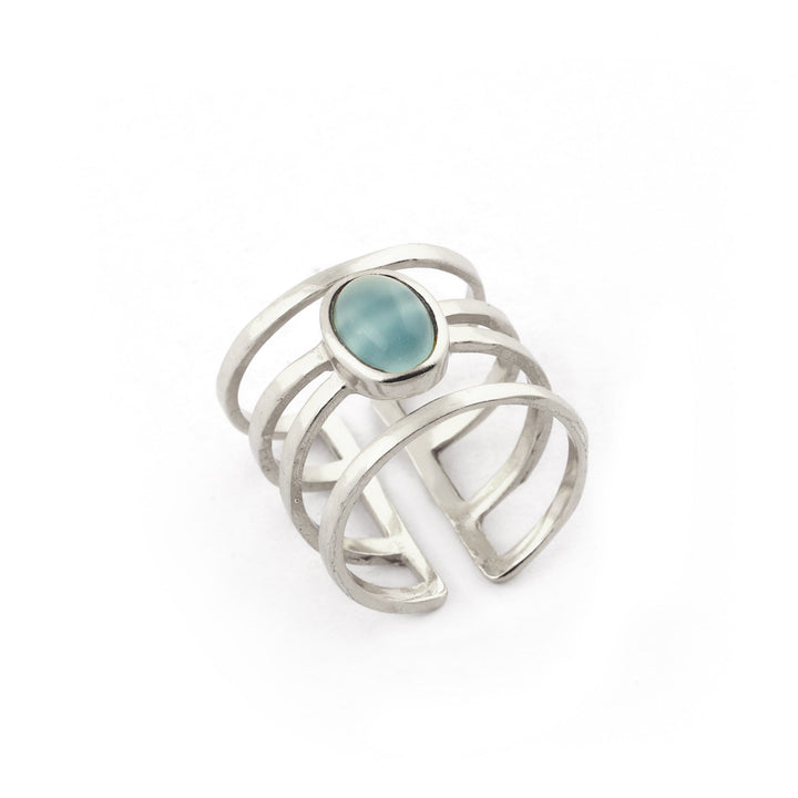 Discover the Andi Banded Ring in Amazonite by Watermelon Tropical, a minimalist yet elegant sterling silver ring. This modern design features an open band with multiple parallel lines and is adorned with a central oval Amazonite stone. The white background highlights its intricate design details beautifully.