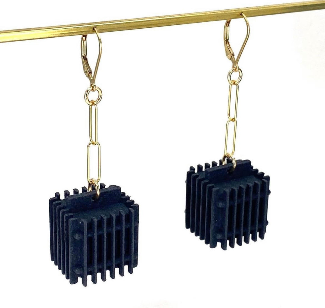 The Elsiem Vibe Fin Cube Earrings feature gold-colored hooks and chain links with black, ribbed geometric cube pendants—modern statement earrings perfect for adding an edge to your style.