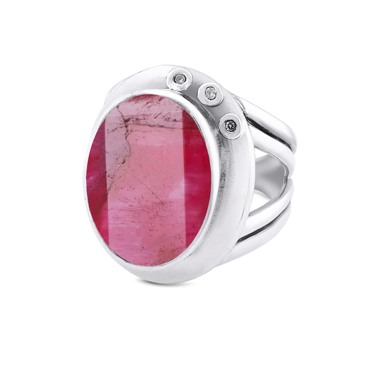 The Eyetelia Ring by Gallardo & Blaine Designs features a large oval pink gemstone at its center, accented with three small round diamonds set in sterling silver. Available in various gemstones.