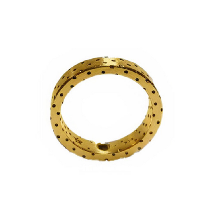 The Fruit Bijoux Dots Ring by Fruit Bijoux features a smooth 24ct gold-plated silver band with evenly spaced black polka dots, elegantly displayed on a white background.