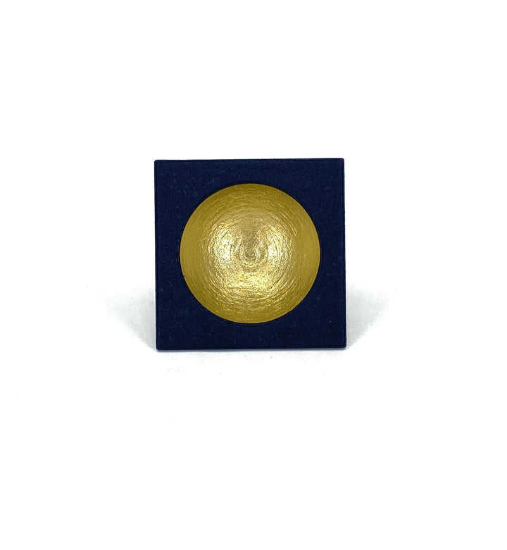 A small, square, dark blue pan showcases Elsiem's Vibe Gold Dome Ring pigment, hand painted with a gold dome at the center and displayed on a plain white background.