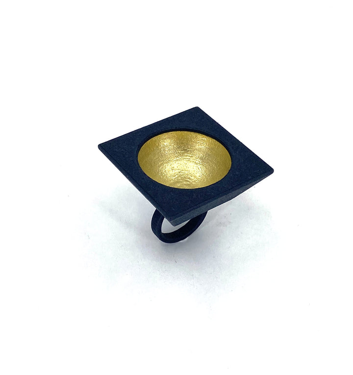 The Elsiem Vibe Gold Dome Ring is a modern statement piece with a black square 3D printed SLS Nylon top, featuring a hand-painted gold dome at its concave center, shown against a white background.