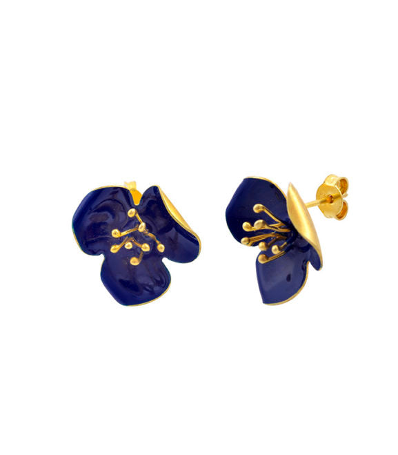 Georgia Charal's Gold Enamel Poppy Stud Earrings feature glossy dark blue flower-shaped petals with gold detailing at the center, displayed on a white background.