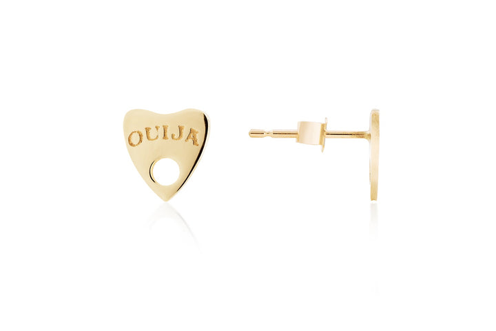 A pair of Ouija 9ct Gold Earrings by Cosmic Boulevard shaped like the mystical planchettes used with Ouija boards. One earring is displayed front-facing with the word "Ouija" engraved on it, while the other is shown from the side to reveal its post and back, embodying a touch of handmade mysticism and spirituality.