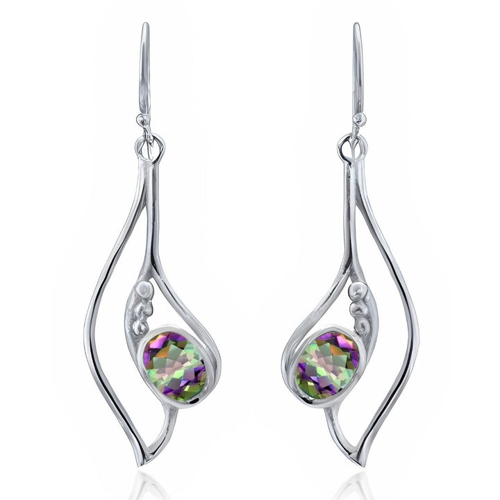 Add shine to your style with the Iris Earrings in various gemstones by Gallardo & Blaine Designs—dangle earrings featuring abstract silver frames and faceted oval stones in green, purple, and clear hues.