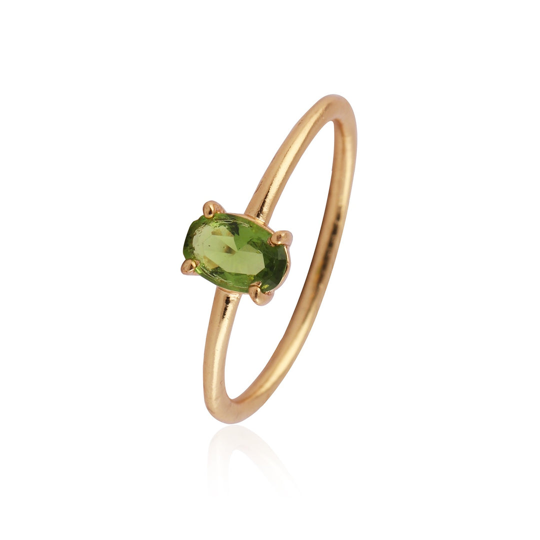 simple thin, gold plated band with a delicate peridot in a claw bezel