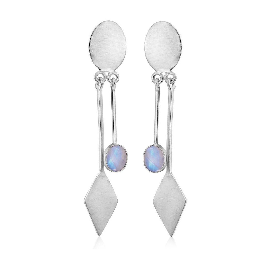 The Karo Earrings by Gallardo & Blaine Designs feature silver oval studs with geometric dangles and iridescent round gemstones, embodying modern elegance.