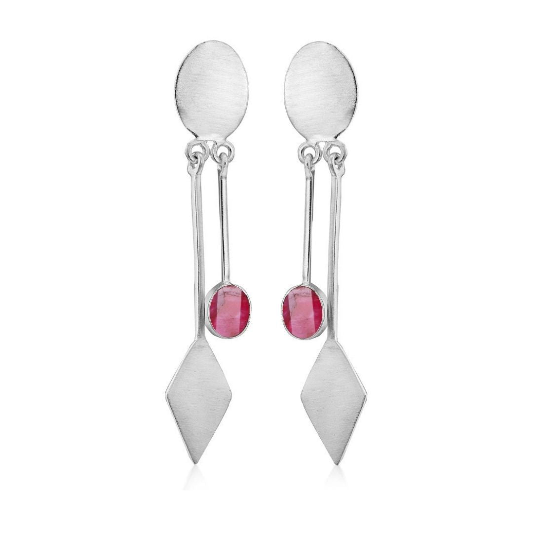 Discover the Karo Earrings by Gallardo & Blaine Designs, where modern elegance meets unique design. These silver dangle drops feature oval tops, rectangular bars with centrally set small round red gemstones, and diamond-shaped bottom pieces. Available in various gemstones.