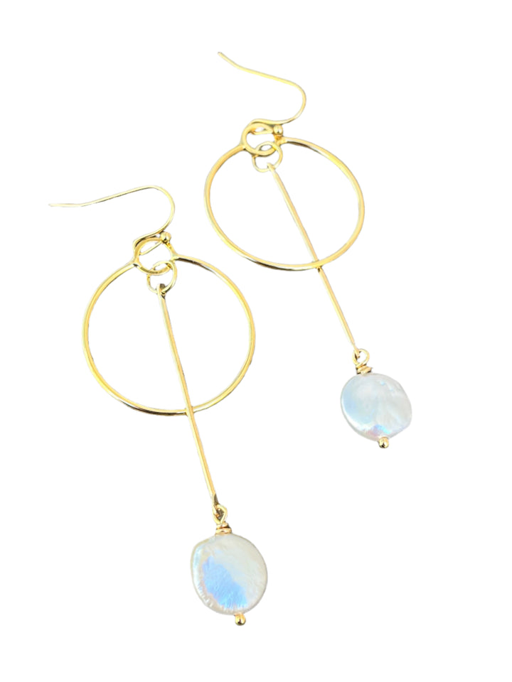 The Kea Earrings with Freshwater Pearl Drops by Kybalion Jewellery are gold plated hoops with a vertical bar and iridescent pearl, inspired by handmade Dublin jewelry and shown on a white background.