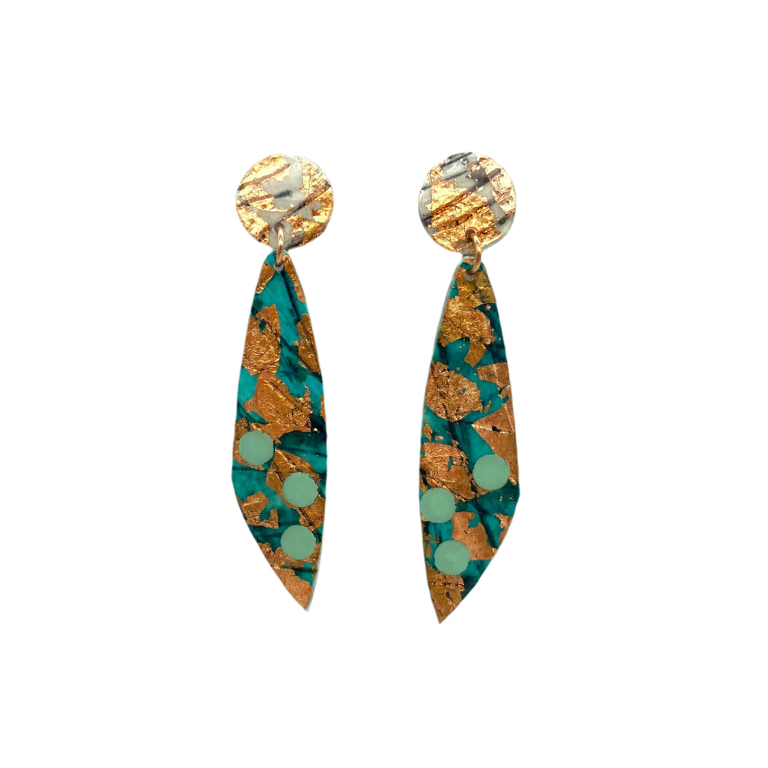 A pair of earrings with circular tops and elongated, pointed drops. Featuring unique sgraffito textile designs with turquoise, gold leaf, and light green dot patterns on a marbled texture, these hypoallergenic ear studs offer an abstract and artistic appearance. The Moondrifter Sgraffito Textile Earrings in Sea Green/Rose Gold by Rothlú are set against a plain white background.