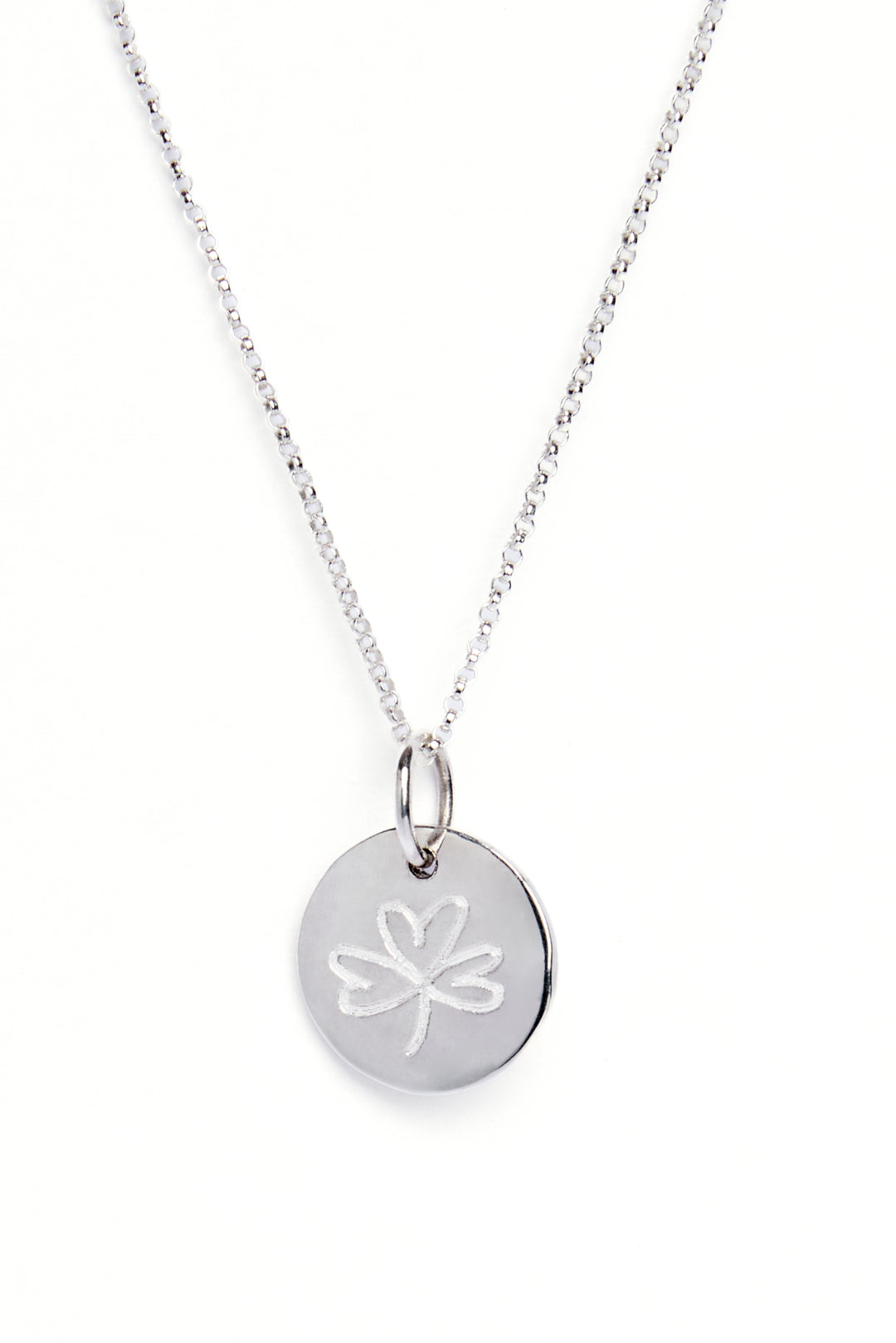 A sterling silver necklace with a round organic shaped circle pendant measuring 15mm in diameter which has a subtle indent in the centre. This pendant has been engraved with a shamrock on the reverse.