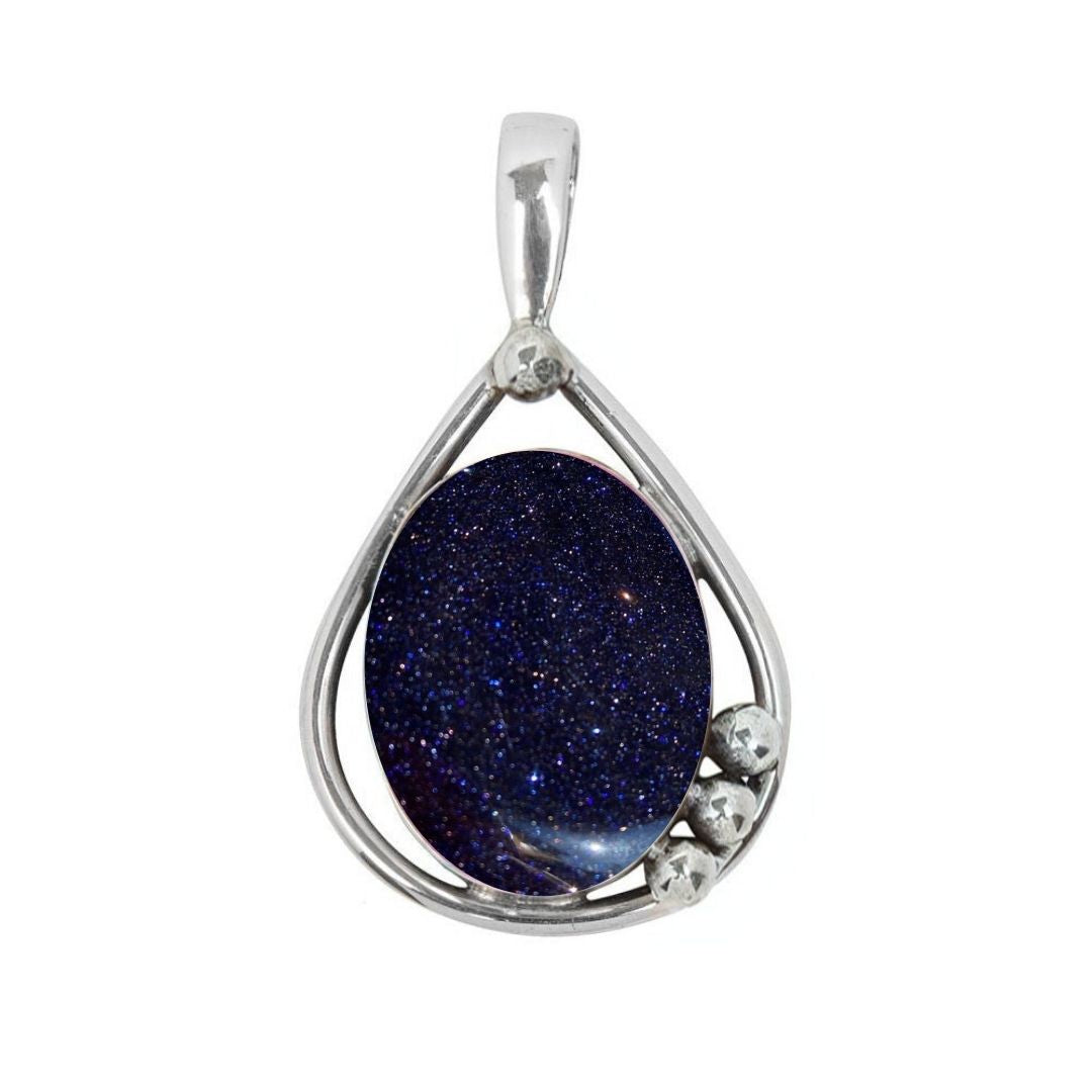 The Poppy Pendant Small by Gallardo & Blaine Designs features a teardrop-shaped sterling silver setting with an oval dark blue gemstone and three silver bead accents, offering a touch of elegance.