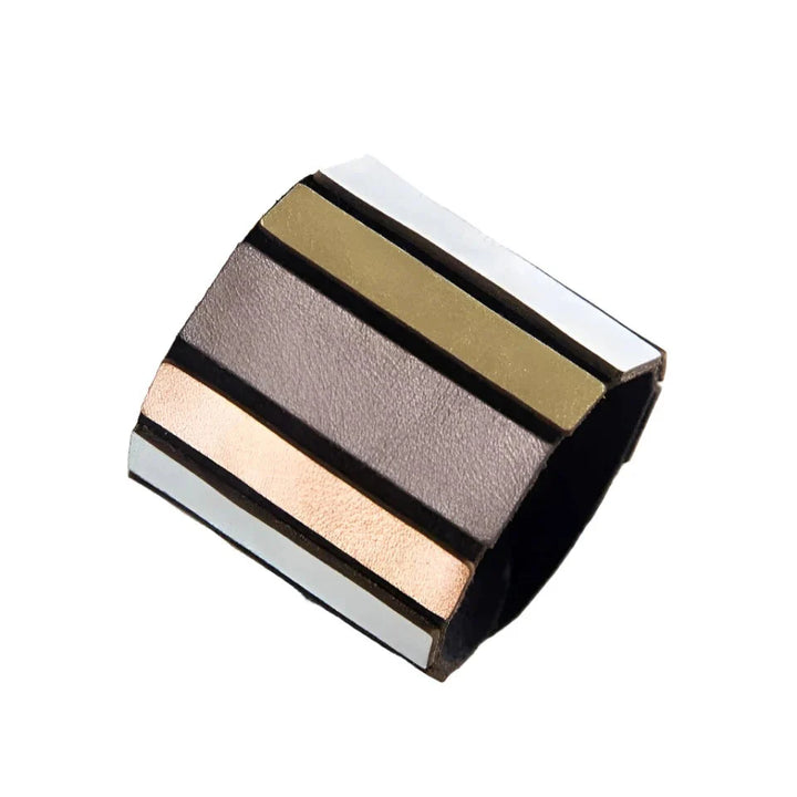 The Iskin Sisters Rainbow Round Bracelet features alternating gold, copper, silver, and black metallic stripes on a smooth, wide band—ideal for lovers of lightweight jewelry—displayed on a white background.