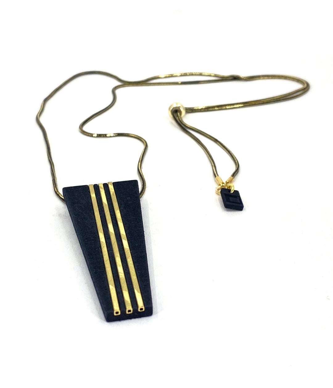The Elsiem Rapture Warrior Necklace features a 3D-printed black trapezoidal pendant with three vertical gold lines and a matching charm on a slim black and gold snake chain, shown against a white background.