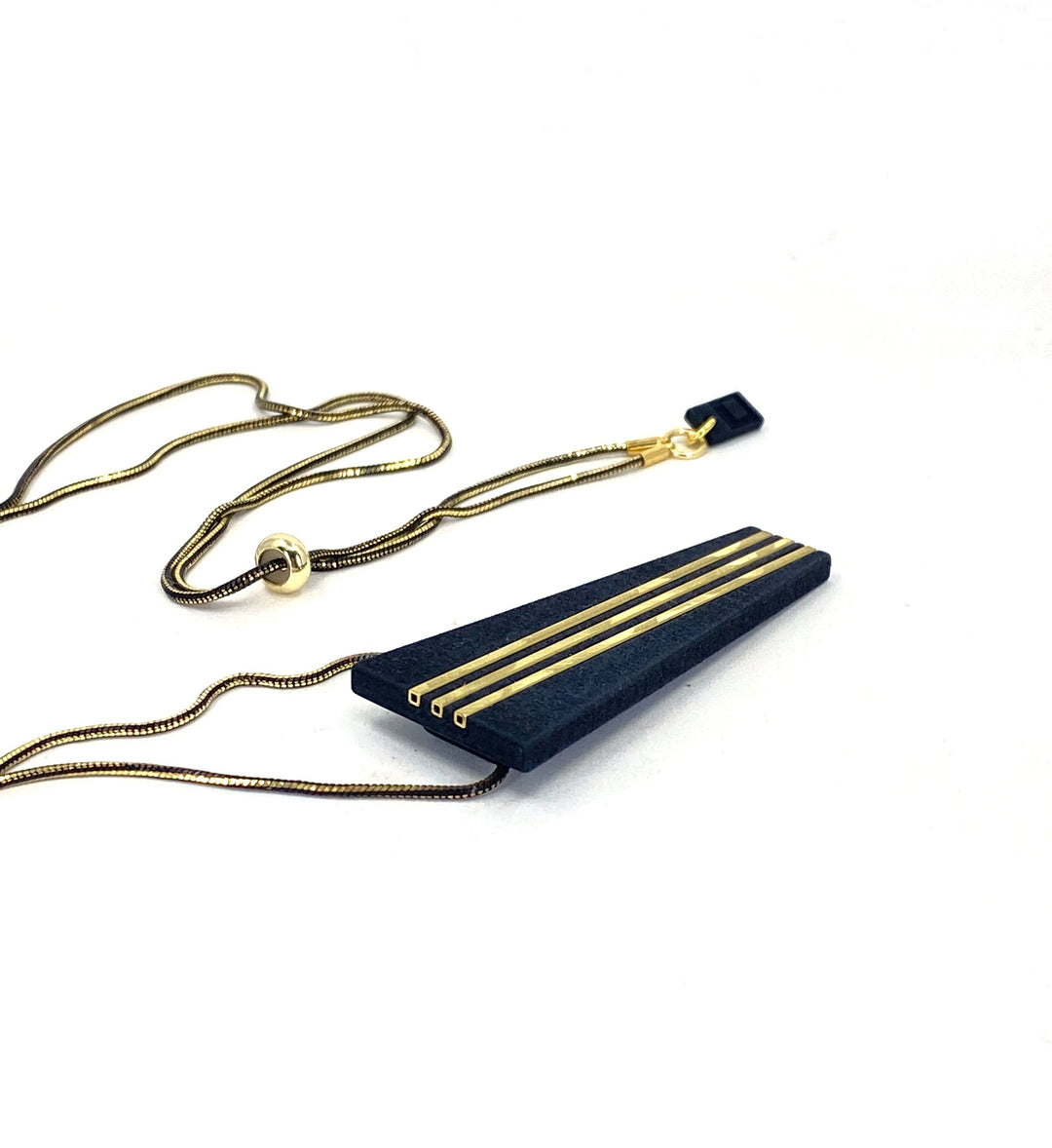 The Elsiem Rapture Warrior Necklace pairs a shiny gold and black snake chain with a modern, minimalist 3D-printed black pendant featuring four parallel gold lines and a sleek tapered rectangular shape.
