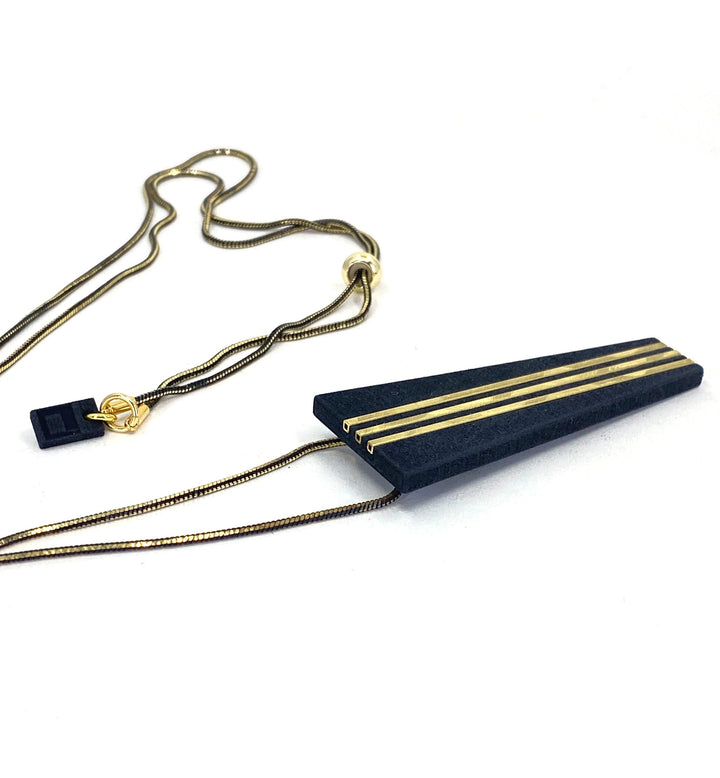 The Elsiem Rapture Warrior Necklace features a gold snake chain and a black, trapezoid-shaped 3D printed pendant with three parallel gold lines, displayed on a white background.