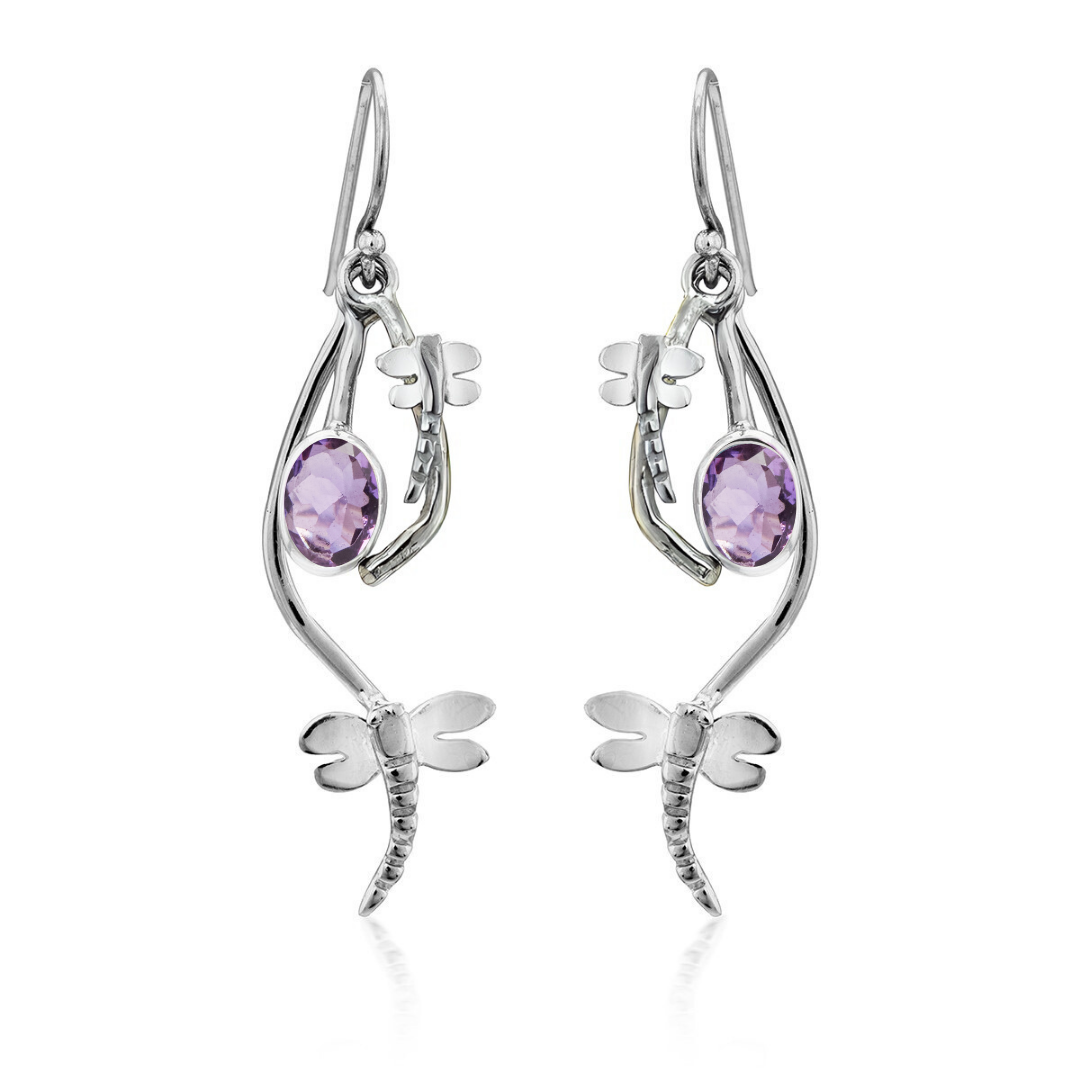 The Ripple Earrings by Gallardo & Blaine Designs feature a sterling silver dragonfly design with an oval light purple gemstone at the center, offering a charming and elegant take on gemstone earrings.