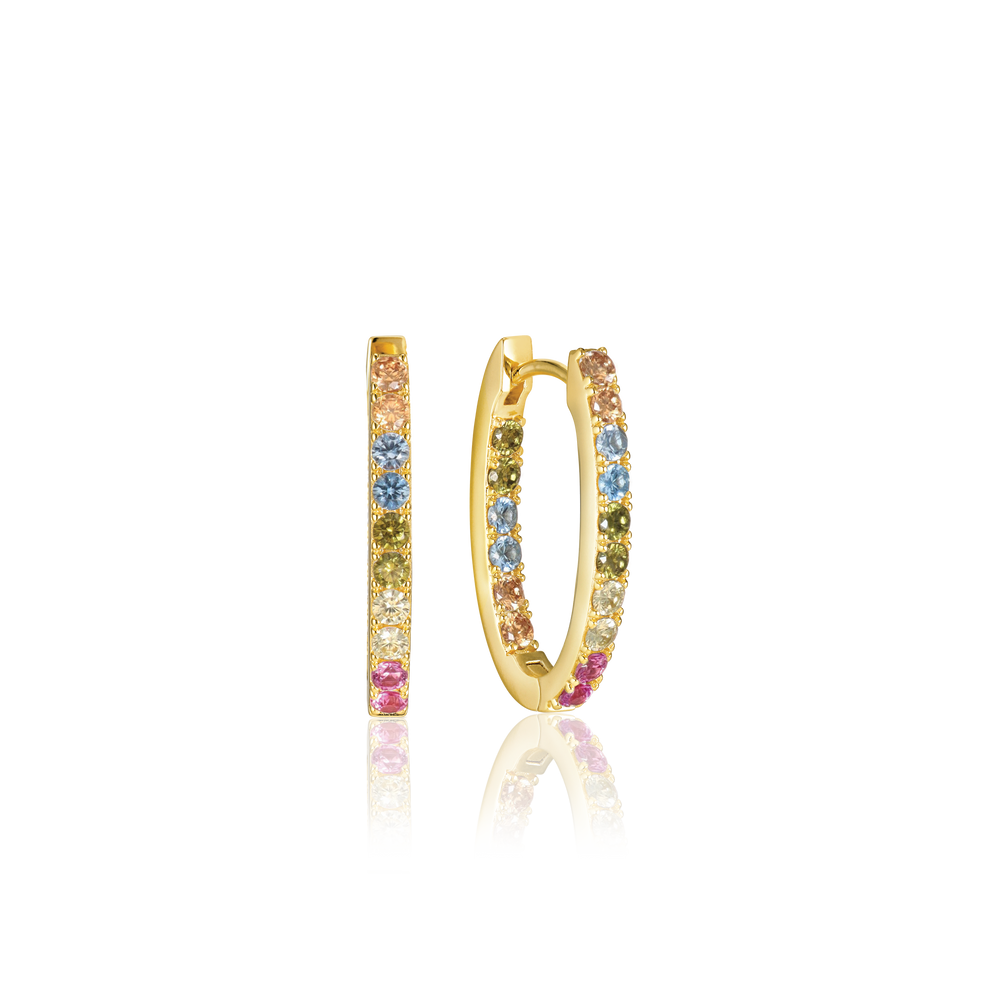 The Ellisse Piccolo Oval Hoop Earrings by Sif Jacobs are gold-plated, featuring vibrant pink, blue, and yellow gemstones. Enhanced with shimmering cubic zirconia accents, these earrings elegantly stand on a black surface, showcasing their stunning colors and design.