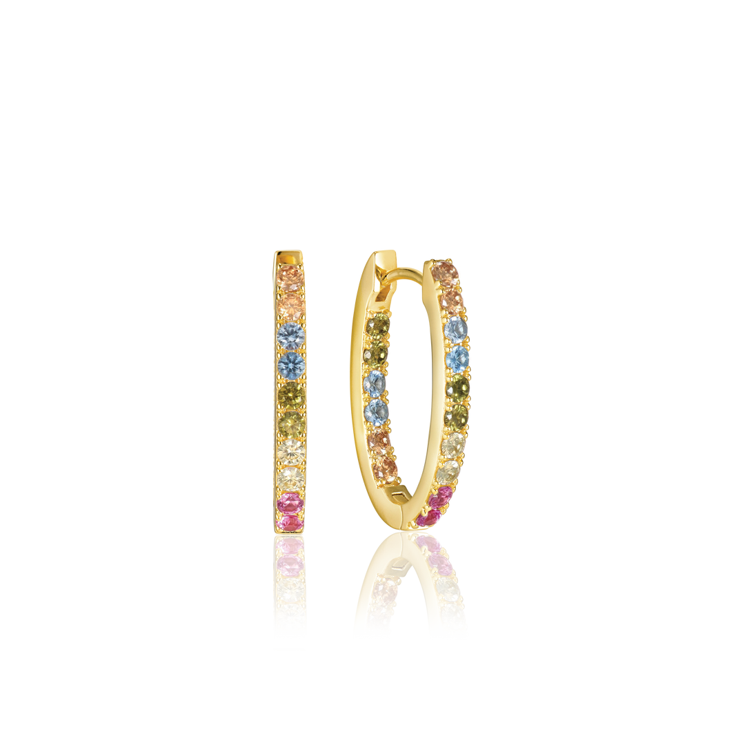 The Ellisse Piccolo Oval Hoop Earrings by Sif Jacobs are gold-plated, featuring vibrant pink, blue, and yellow gemstones. Enhanced with shimmering cubic zirconia accents, these earrings elegantly stand on a black surface, showcasing their stunning colors and design.
