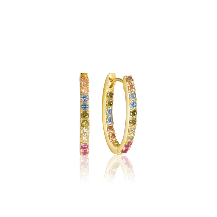 The Ellisse Piccolo Oval Hoop Earrings by Sif Jacobs are gold-plated, featuring vibrant pink, blue, and yellow gemstones. Enhanced with shimmering cubic zirconia accents, these earrings elegantly stand on a black surface, showcasing their stunning colors and design.