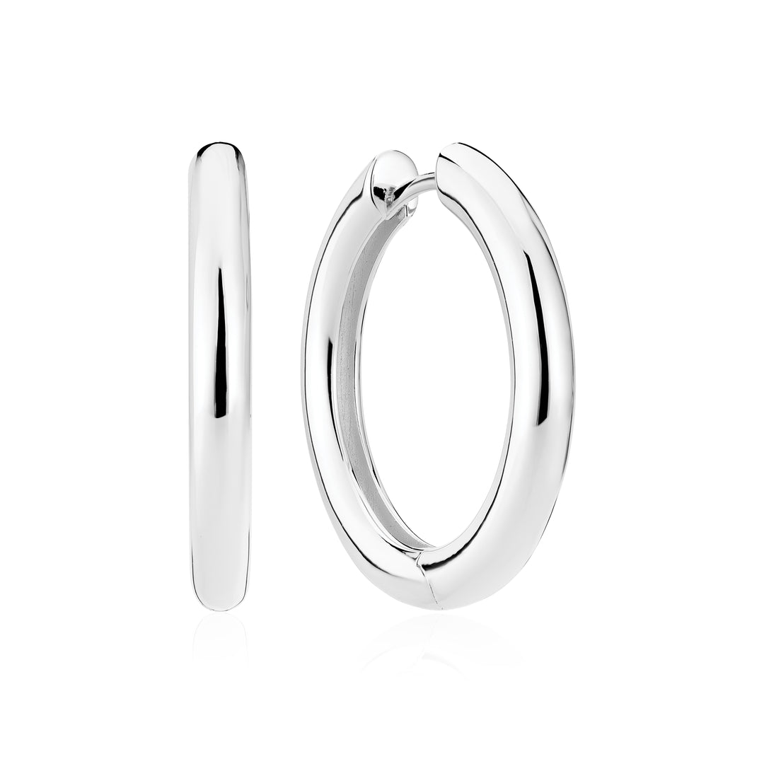 Shown are the Sif Jacobs Carrara Pianura Earrings in polished sterling silver—one displayed from the side to show its thickness, and the other from the front to reveal its circular, smooth, and shiny surface.