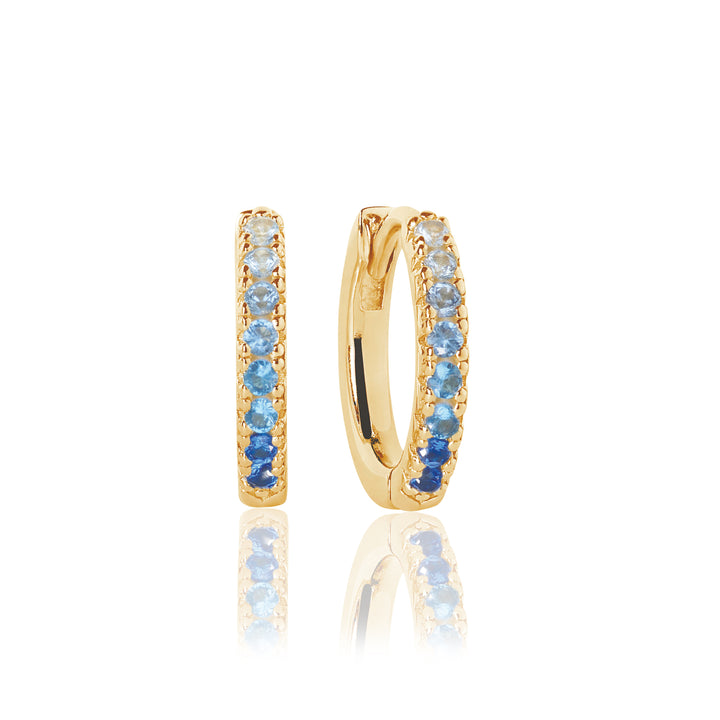 The Sif Jacobs Ellera Medio Hoop Earrings feature small 18k gold-plated sterling silver hoops adorned with blue and light blue cubic zirconia—perfect for upgrading any demi-fine jewellery collection.