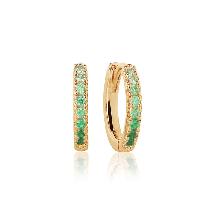 The Sif Jacobs Ellera Medio Hoop Earrings are small hoops crafted from 18k gold plated sterling silver and set with green gemstones, displayed upright on a white background with a subtle reflection beneath.