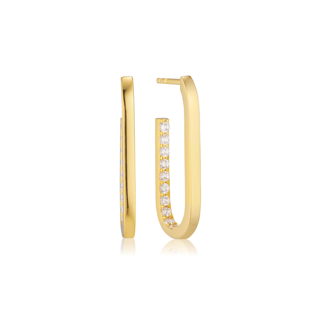 The Sif Jacobs Capizzi Medio Oval Hoop Earrings feature a modern gold-plated rectangular design with a row of sparkling cubic zirconia on the front, shown against a white background.