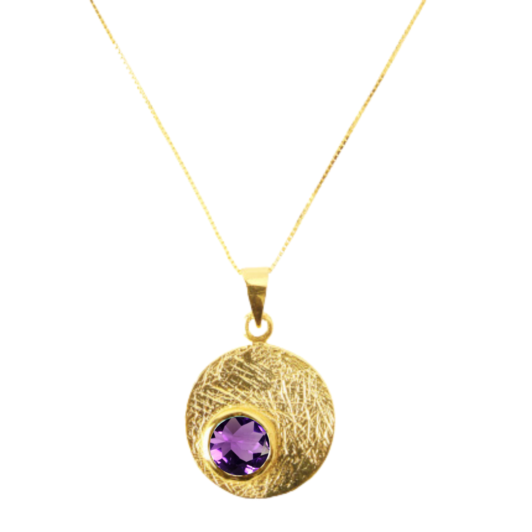 The Selene Necklace Gold - Small by Gallardo & Blaine Designs is a gold-plated necklace with a textured circular pendant featuring a round gemstone at the center.