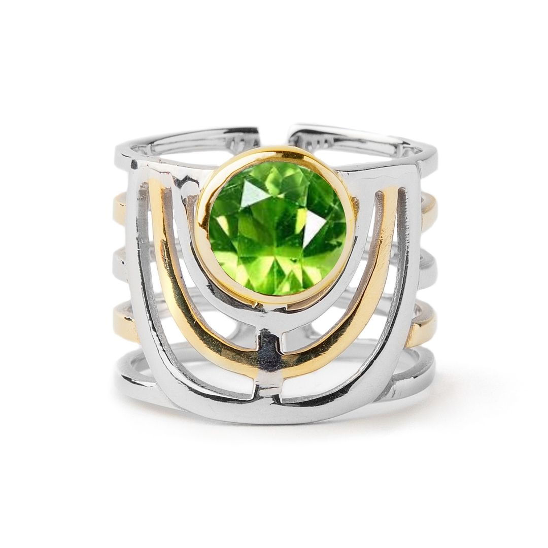 The Solar Ring by Gallardo & Blaine Designs features three open sterling silver bands with gold accents and a large round green gemstone at the center.