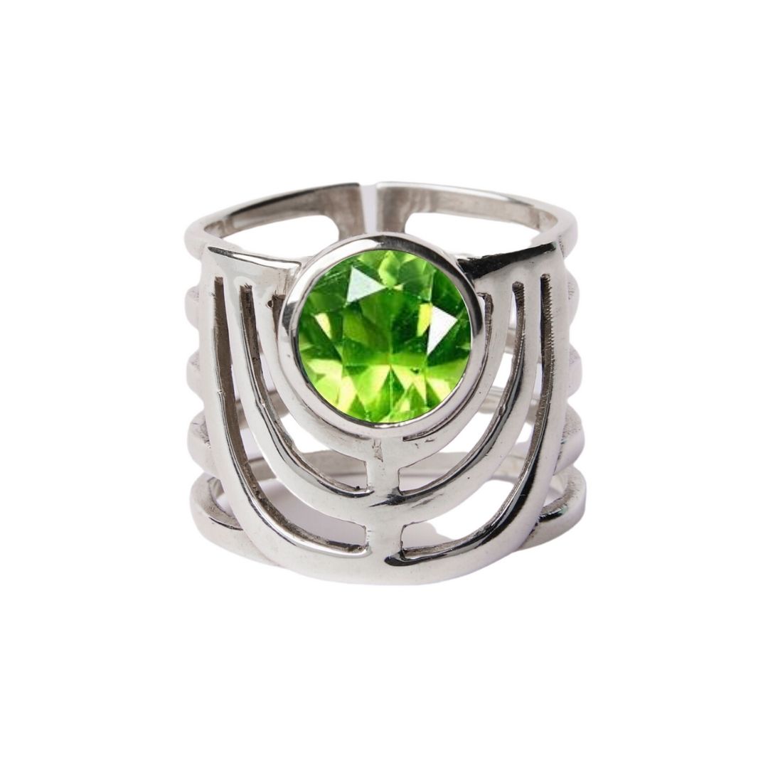 The Solar Ring by Gallardo & Blaine Designs features a chunky, open geometric design in sterling silver with a bold round green gemstone at the center.