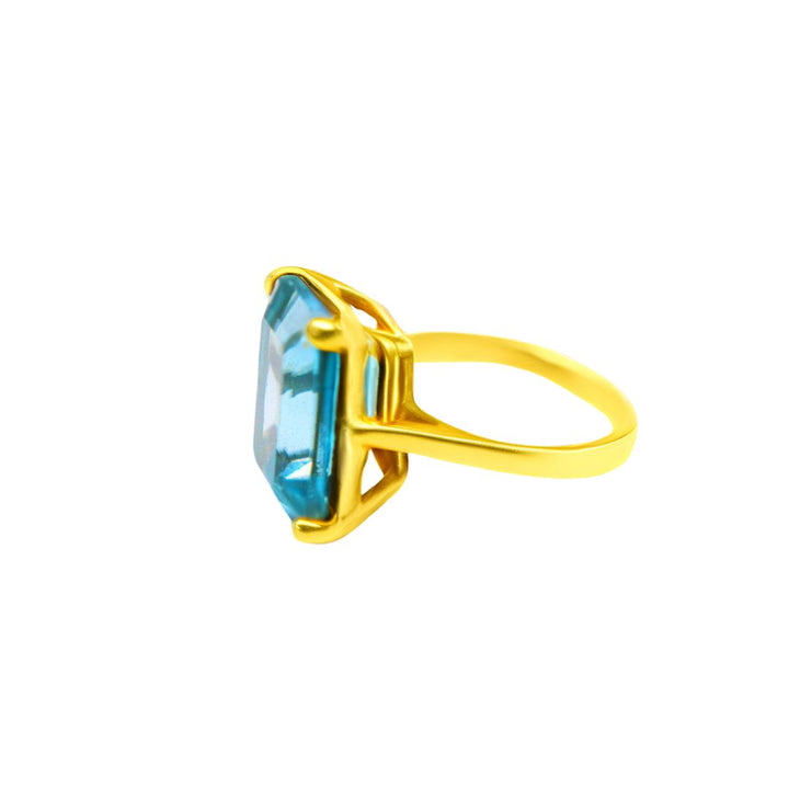 The Stellar Ring in Hydro Blue Topaz by Gallardo & Blaine Designs features a large, rectangular blue stone in a prong setting, displayed from the side on a white background.